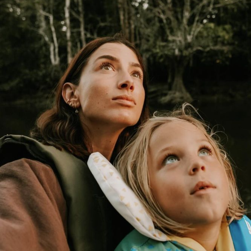 Mother and son looking into the forest canopy