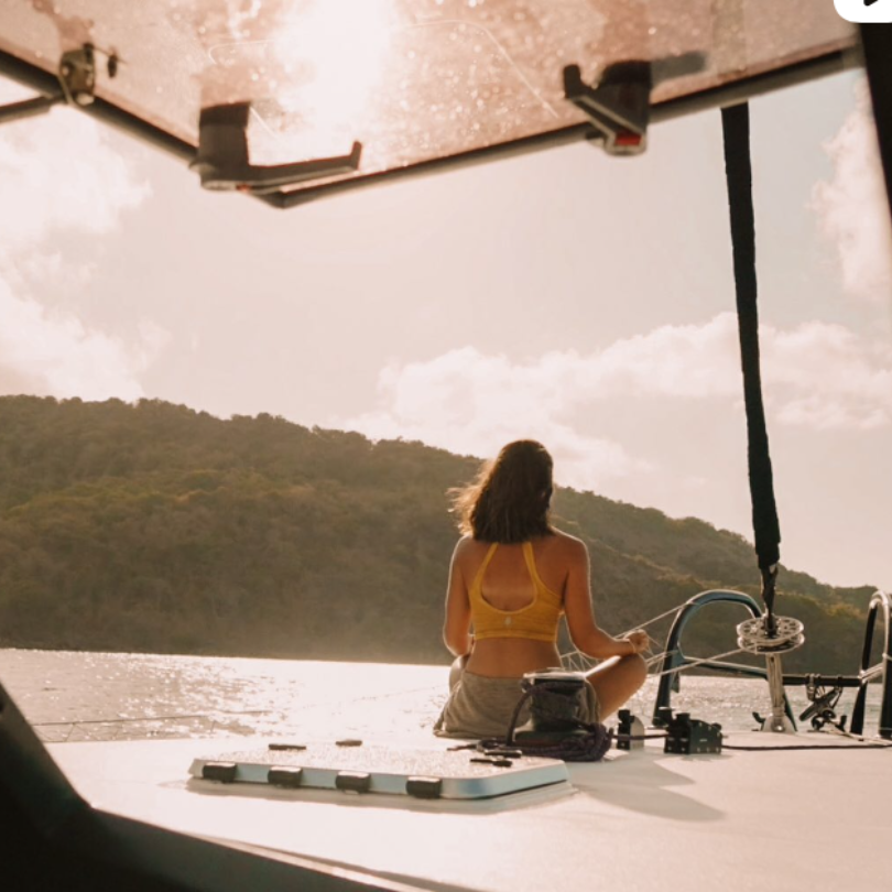 Woman meditating on a boat