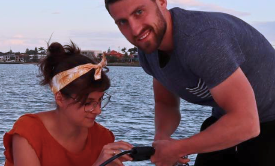 Couple from Sailing Take it Easy refilling scuba tanks